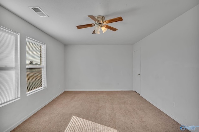 carpeted empty room featuring ceiling fan