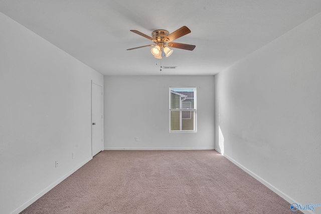 carpeted spare room featuring ceiling fan