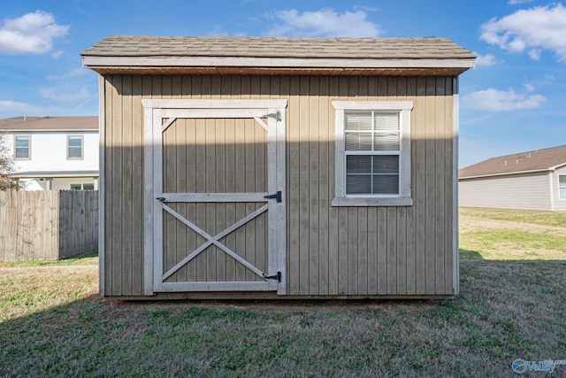 view of outbuilding featuring a lawn