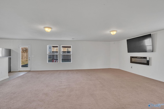 unfurnished living room featuring light colored carpet