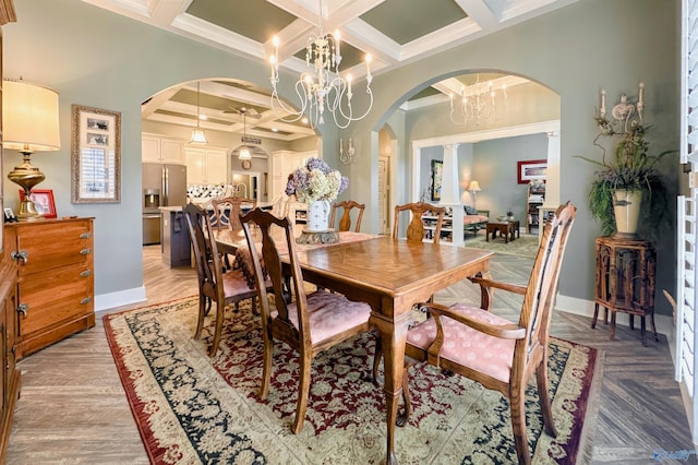 dining room with arched walkways, coffered ceiling, a notable chandelier, and beam ceiling