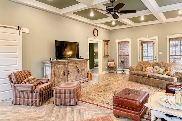 living room with a barn door, coffered ceiling, a ceiling fan, beamed ceiling, and baseboards