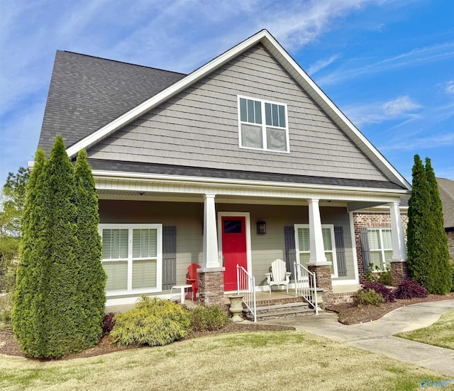 view of front of home with a front lawn and a porch
