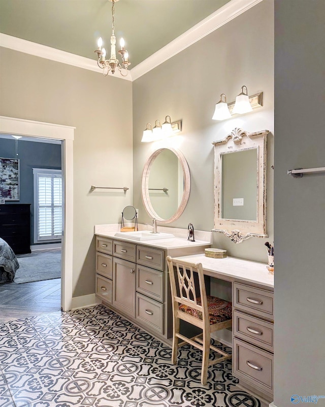 ensuite bathroom with baseboards, a notable chandelier, crown molding, vanity, and connected bathroom