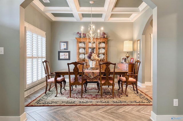 dining space with a wealth of natural light, arched walkways, a notable chandelier, and coffered ceiling