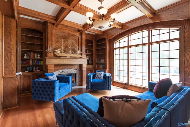 sitting room featuring hardwood / wood-style flooring, coffered ceiling, and a premium fireplace