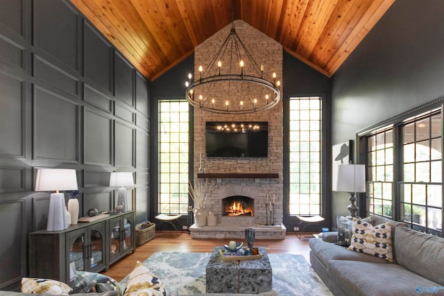 living room featuring high vaulted ceiling, a healthy amount of sunlight, and a fireplace