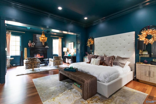 bedroom with ornamental molding and hardwood / wood-style floors