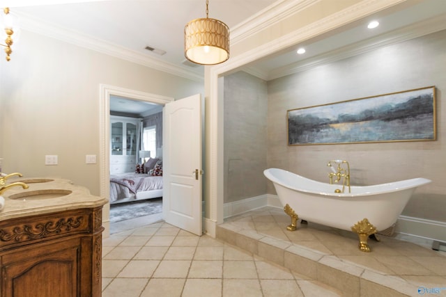 bathroom featuring vanity, ornamental molding, tile patterned floors, and a bathtub