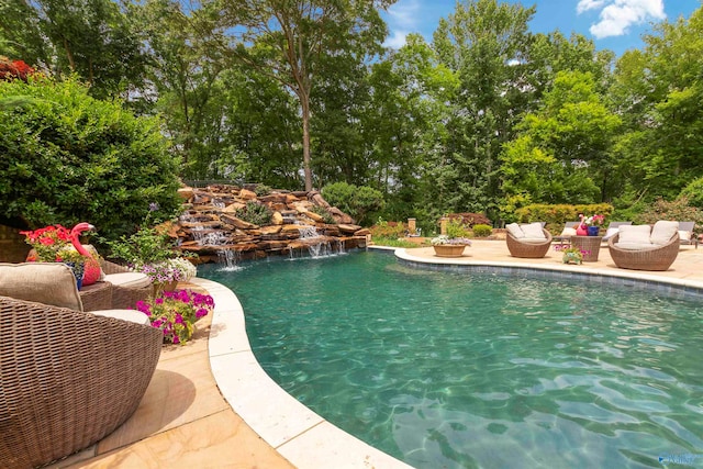 view of pool with a patio area and pool water feature