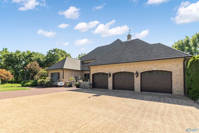 french country style house featuring a garage