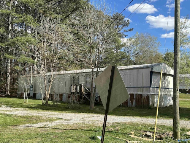 exterior space with an outbuilding, a yard, and a pole building