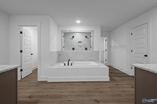 bathroom with vanity, wood-type flooring, and independent shower and bath