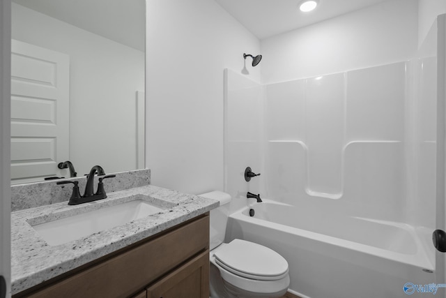 full bathroom featuring vanity, shower / washtub combination, and toilet