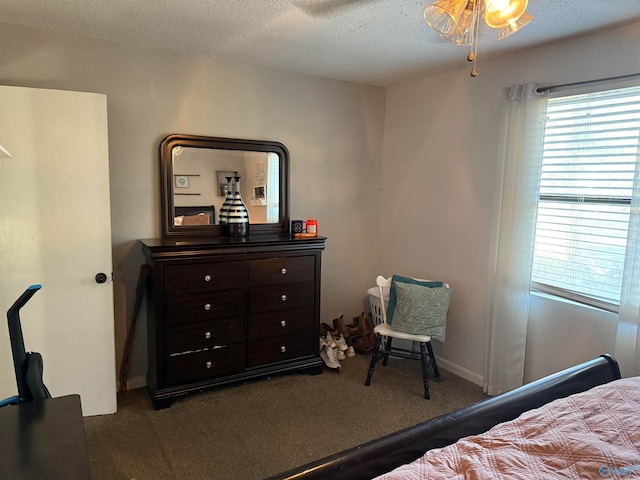 carpeted bedroom with a textured ceiling and ceiling fan