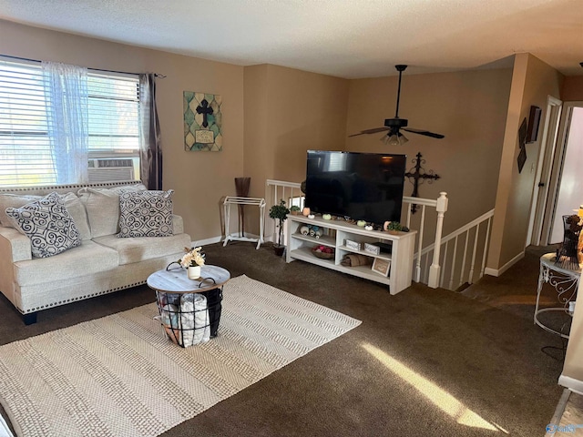 living room featuring cooling unit, a textured ceiling, ceiling fan, and dark colored carpet