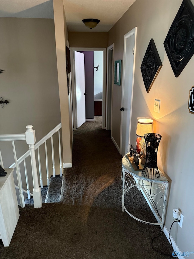 corridor with dark colored carpet