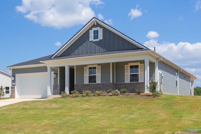 view of front of home featuring a porch, a garage, and a front yard