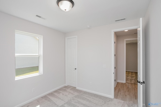 unfurnished bedroom with light carpet