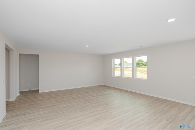 spare room featuring light hardwood / wood-style flooring