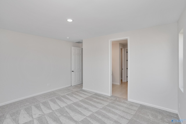 unfurnished room with light colored carpet