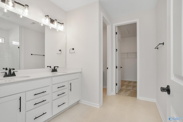 bathroom with vanity and a shower