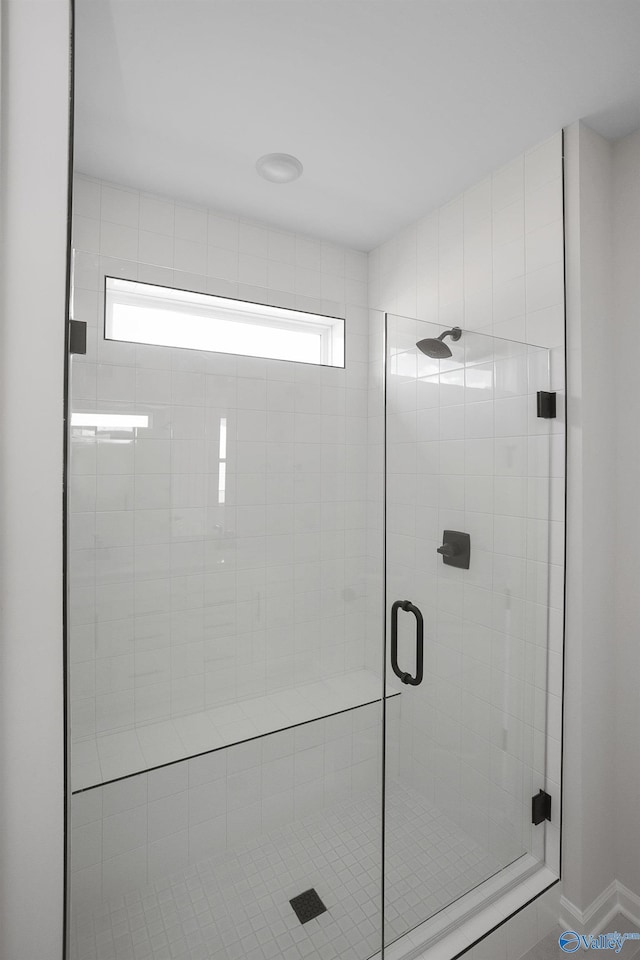 bathroom with a shower with door