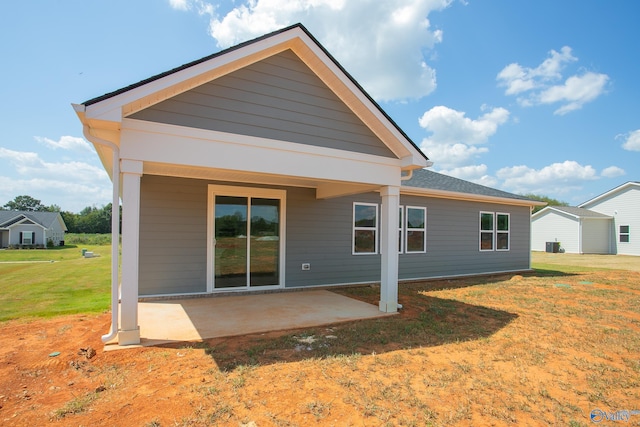 back of house with a yard and a patio area