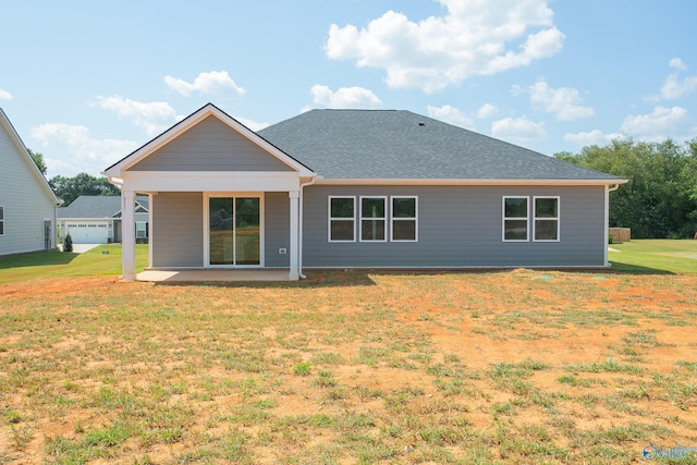 rear view of property with a patio area and a lawn