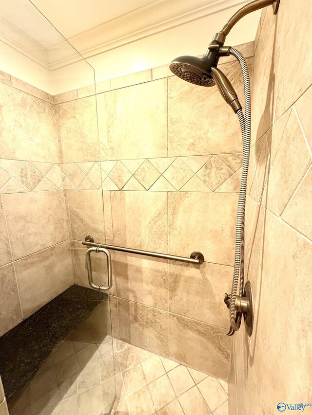 bathroom featuring ornamental molding and walk in shower