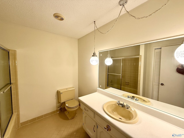 full bathroom featuring tile patterned floors, toilet, combined bath / shower with glass door, a textured ceiling, and vanity