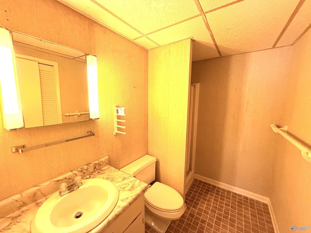 bathroom featuring vanity, toilet, an enclosed shower, and tile patterned flooring