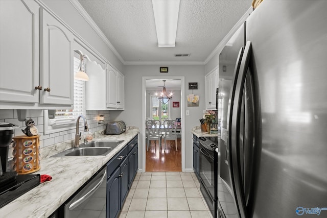 2413 Remington Cir SW, Decatur, AL 35601 - kitchen featuring appliances with stainless steel finishes, white cabinetry, tasteful backsplash, a textured ceiling, and light tile patterned floors
