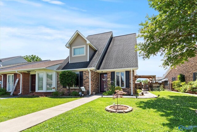 2413 Remington Cir SW, Decatur, AL 35601 - view of front of house with a front yard, brick siding, roof with shingles, and a patio