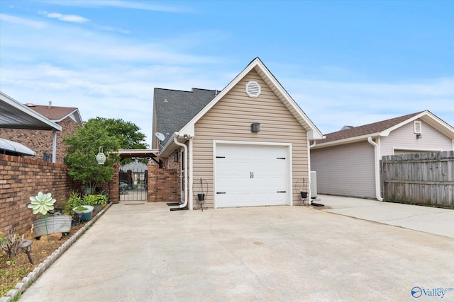 2413 Remington Cir SW, Decatur, AL 35601 - view of side of home featuring an attached garage, concrete driveway, a gate, and a shingled roof