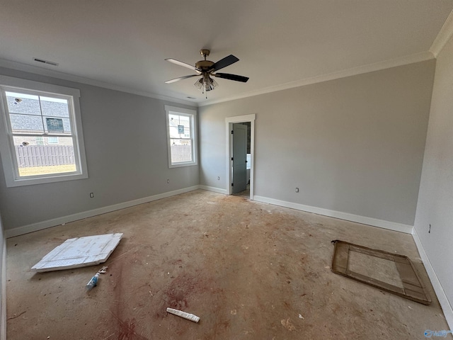 spare room with baseboards, visible vents, a ceiling fan, and crown molding