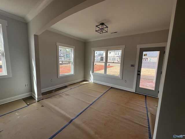 unfurnished dining area with visible vents, crown molding, and baseboards