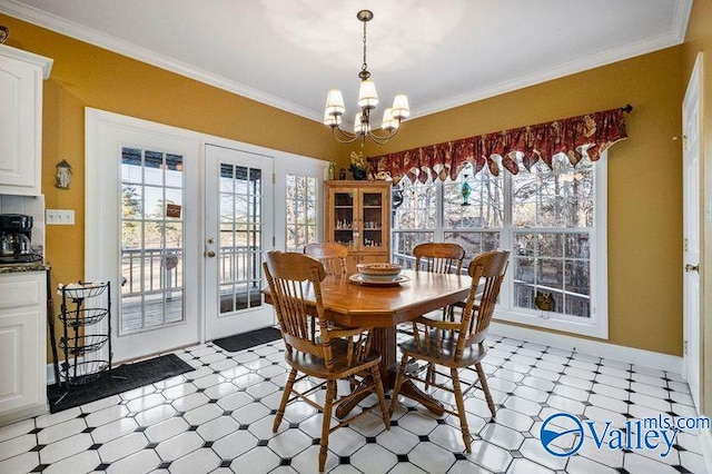 dining area featuring ornamental molding, plenty of natural light, a chandelier, and french doors