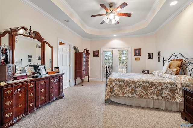 carpeted bedroom with ornamental molding, access to outside, ceiling fan, and a tray ceiling