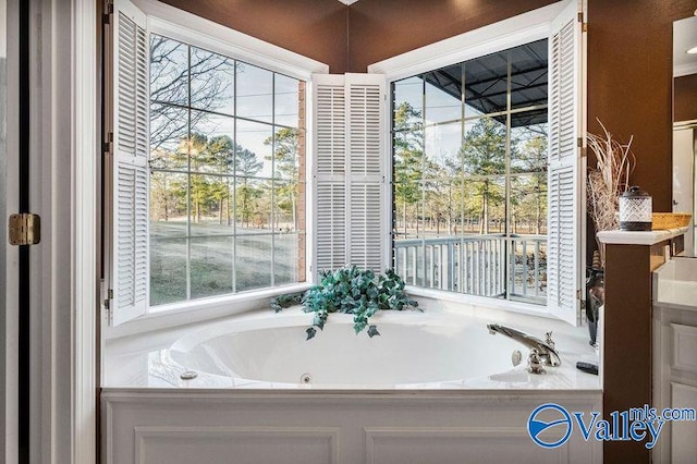 bathroom featuring a wealth of natural light and a bathtub