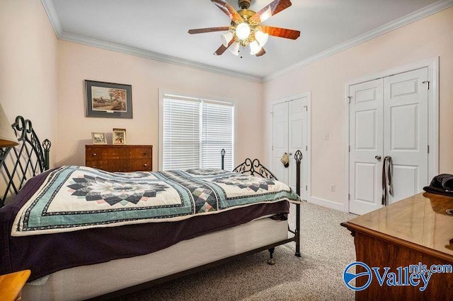 bedroom featuring two closets, crown molding, ceiling fan, and carpet