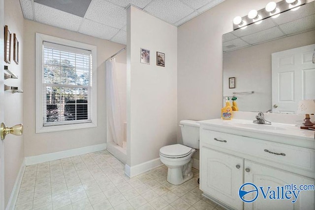 bathroom with a shower with curtain, a paneled ceiling, and vanity