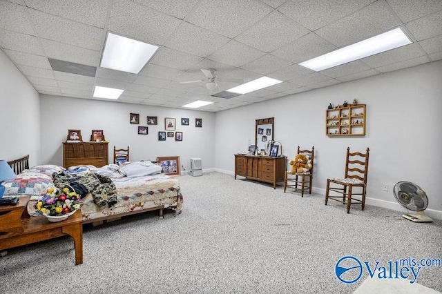 carpeted bedroom with a drop ceiling and ceiling fan