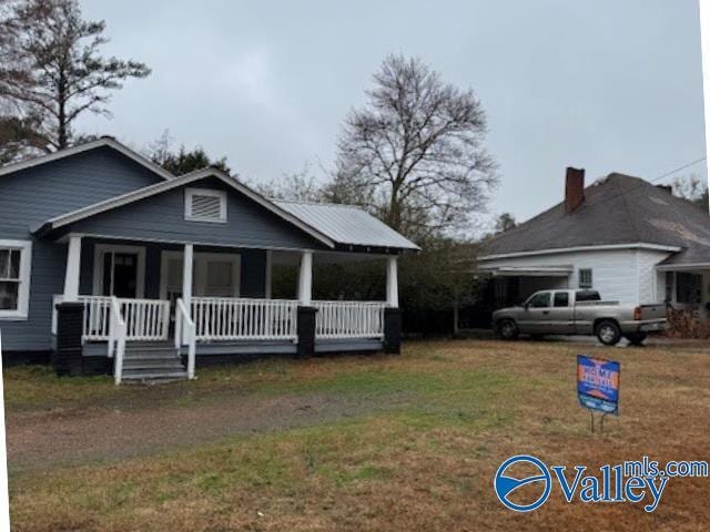 view of front of home with a front lawn and a porch