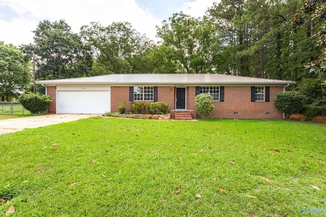 single story home featuring a garage and a front lawn