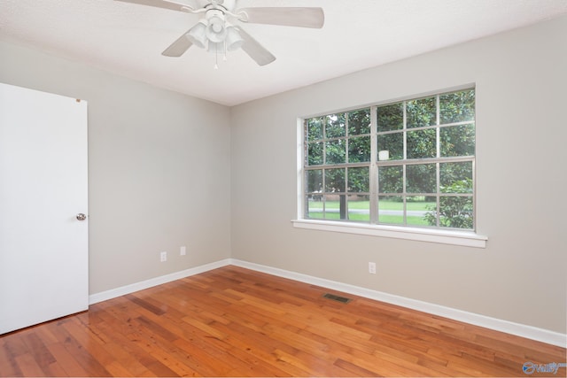 unfurnished room featuring hardwood / wood-style flooring and ceiling fan