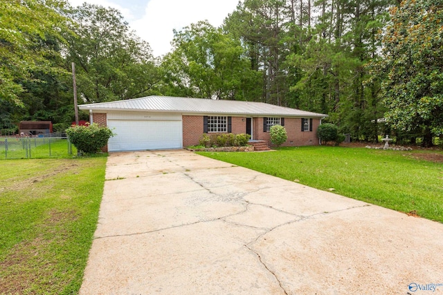 ranch-style home with a garage and a front lawn