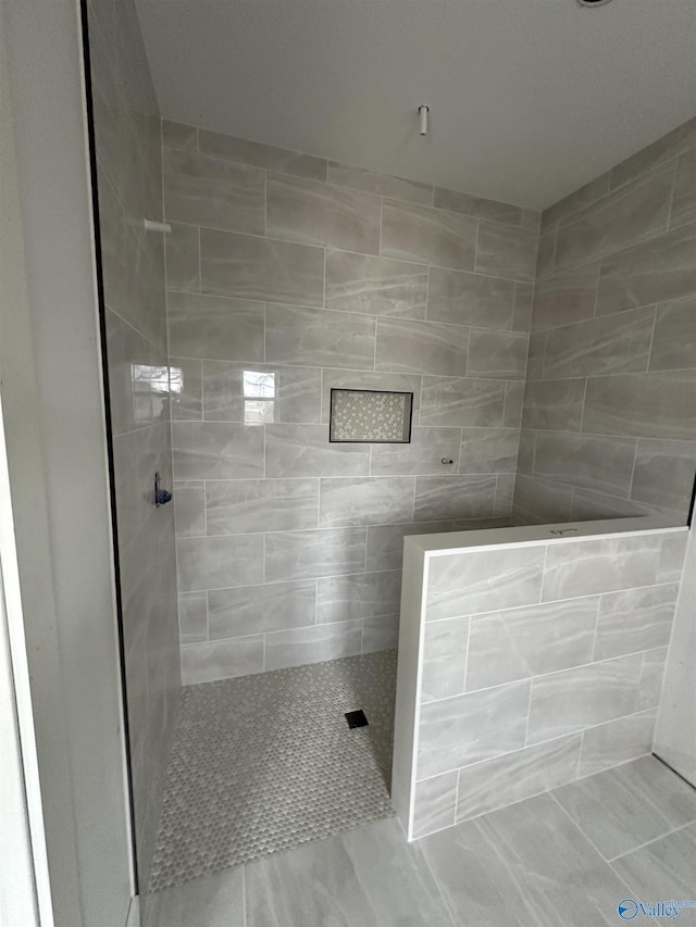 bathroom with tiled shower