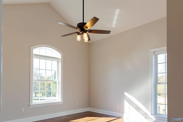 spare room with plenty of natural light, ceiling fan, and vaulted ceiling