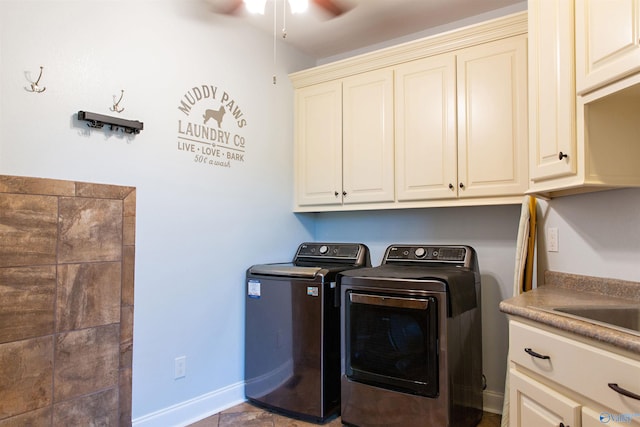 clothes washing area featuring washing machine and dryer, cabinets, and ceiling fan